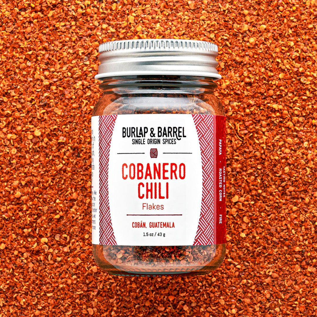 Burlap & Barrel Cobanero Chili Flakes jar on red chili background