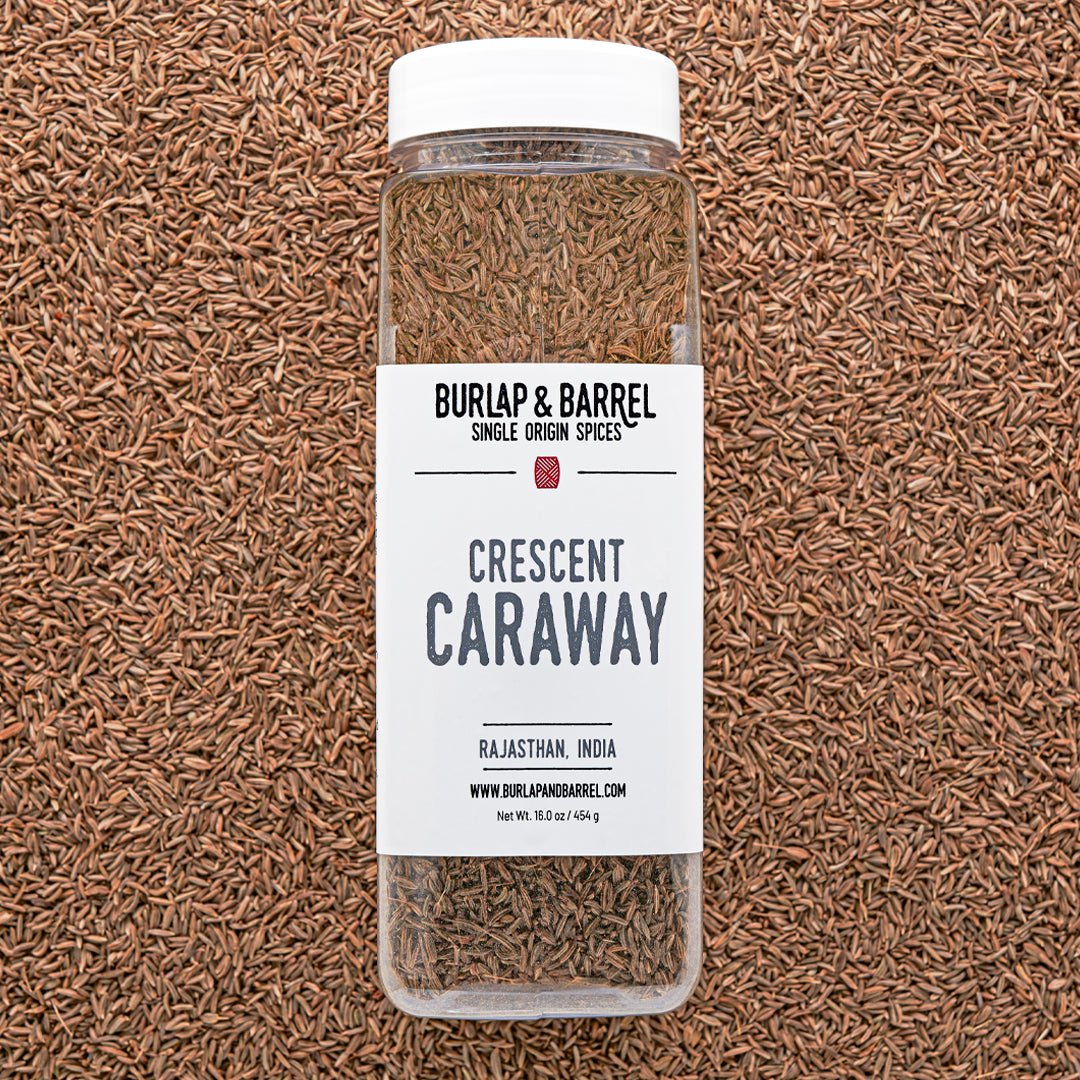 Burlap & Barrel Crescent Caraway spice jar on caraway seeds background