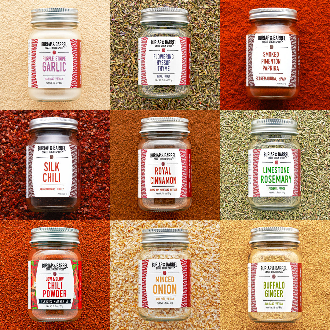 Grid of Burlap & Barrel spice jars with labels on a textured background