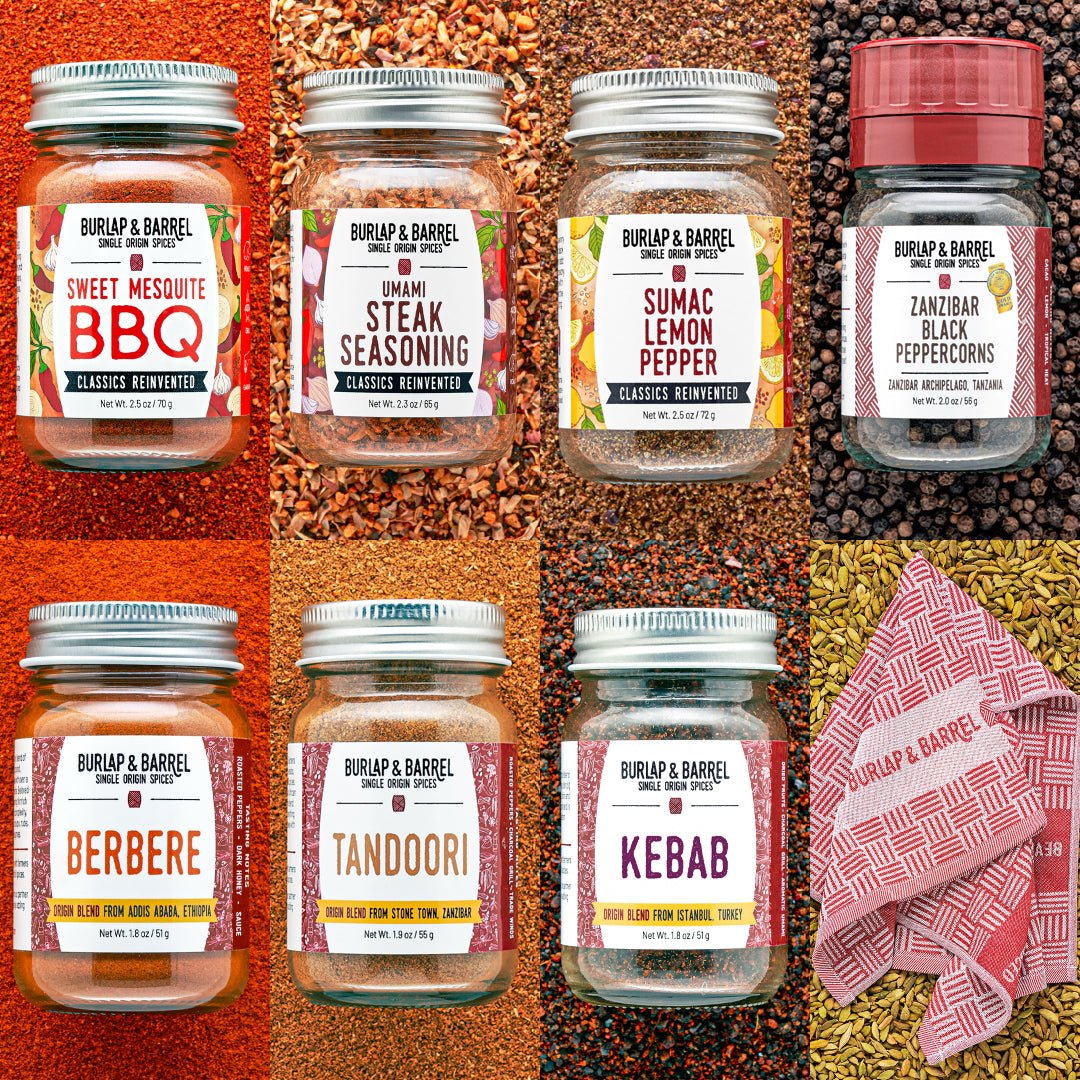 Collection of Burlap & Barrel spice jars on a textured background