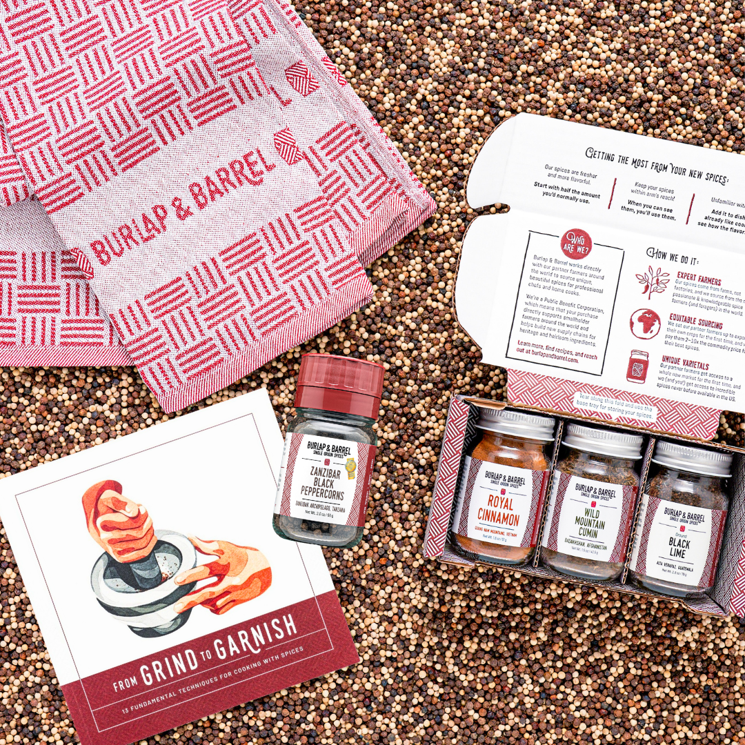 Spice set with jars, a towel, and recipe cards on a textured surface