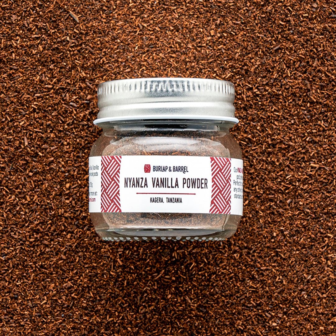 Burlap & Barrel Nyanza Vanilla Powder jar with silver lid on brown textured background