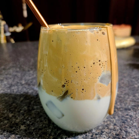 Whipped honey dalgona coffee with foam layered over iced milk. Photo by Burlap & Barrel