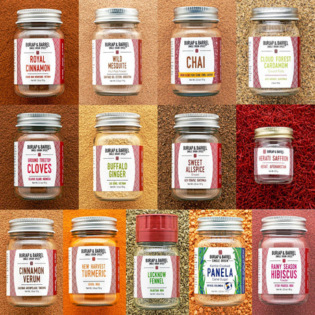 Collection of 13 Burlap & Barrel spice jars on a textured brown background