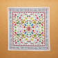 A multicolored, 100% cotton bandana with hand-drawn spice illustrations laid out flat on a surface.