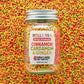 Jar of Molly Yeh & Burlap & Barrel Spiced Sprinkles with colorful sprinkles in the background