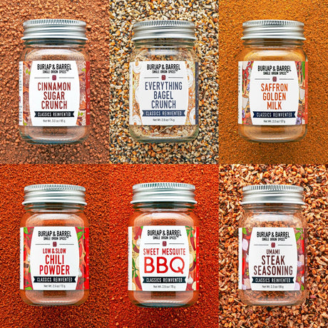 Jars of Burlap & Barrel seasoning mixes on a textured orange background