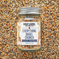 Jar of 'Everything Bagel Crunch' seasoning mix on a textured surface