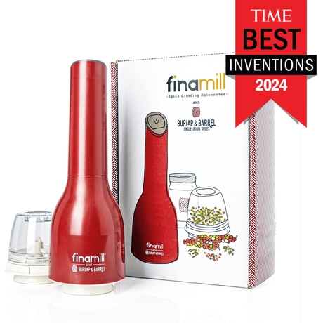 A red Finamill spice grinder with its packaging, displaying the product name and features, alongside three glass jars of spices.