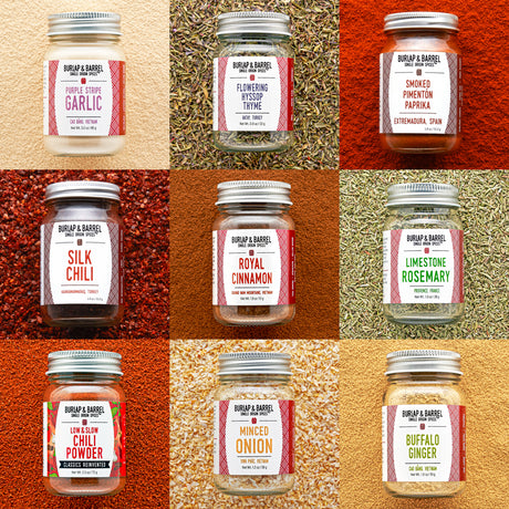 Grid of Burlap & Barrel spice jars with labels on a textured background