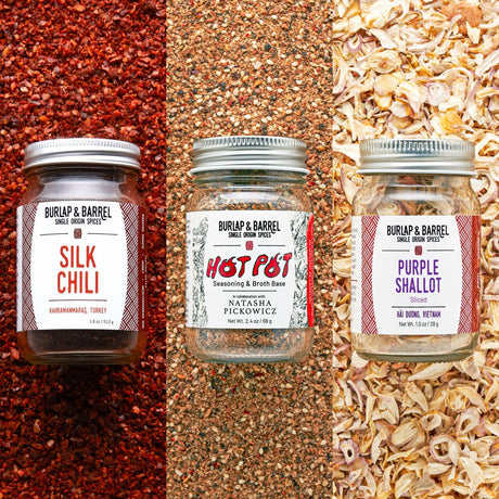 Three jars of Burlap & Barrel spices on a textured background