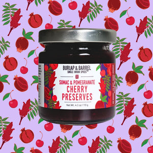 Jar of Burlap & Barrel Sumac & Pomegranate Cherry Preserves on a patterned background