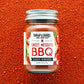 Jar of Burlap & Barrel Sweet Mesquite BBQ spice blend on a red background