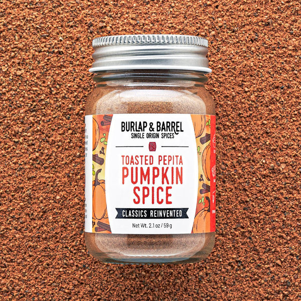 Jar of Burlap & Barrel Toasted Pepita Pumpkin Spice on a brown textured background