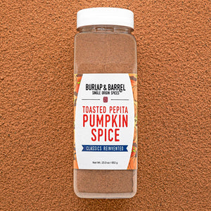Container of Burlap & Barrel Toasted Pepita Pumpkin Spice on a brown background