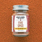 A glass jar with a metal lid labeled 'FIVE SPICE' from Burlap & Barrel on an orange textured background.