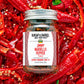 Jimmy Nardello Pepper Flakes jar by Burlap & Barrel on bed of red peppers